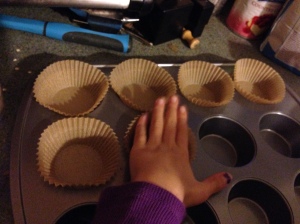 Putting my little sister to good use as the cupcake liner girl
